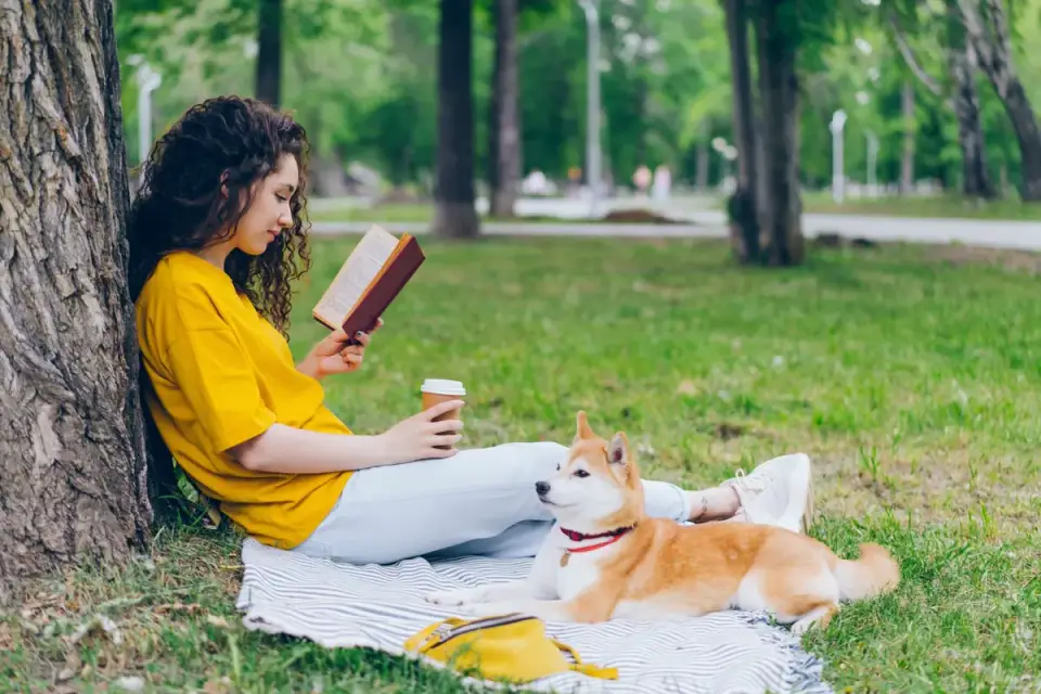 A dog owner reading the ingredient label on a supplement bottle