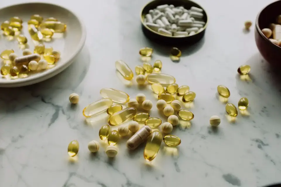 A small pile of chewable dog supplements next to a food bowl