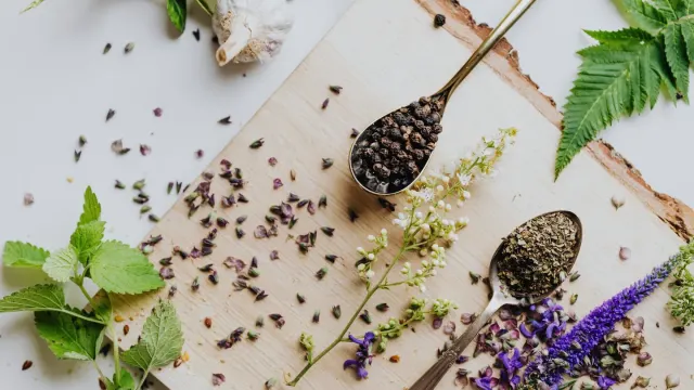 Dried valerian root pieces on a wooden table beside a sleeping dog
